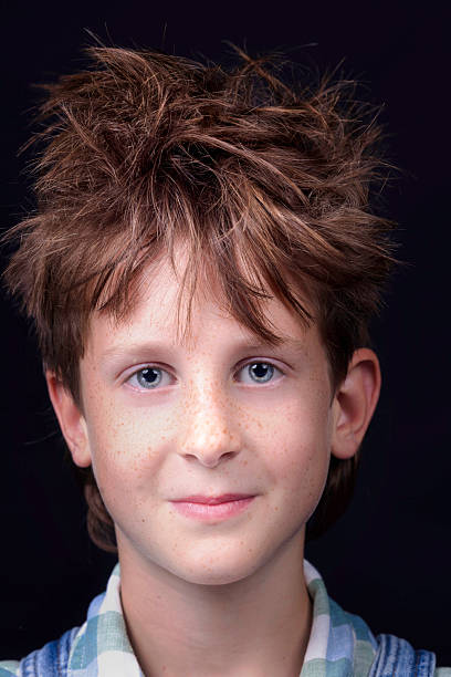 Studio portrait of a brown-haired primary age boy.
