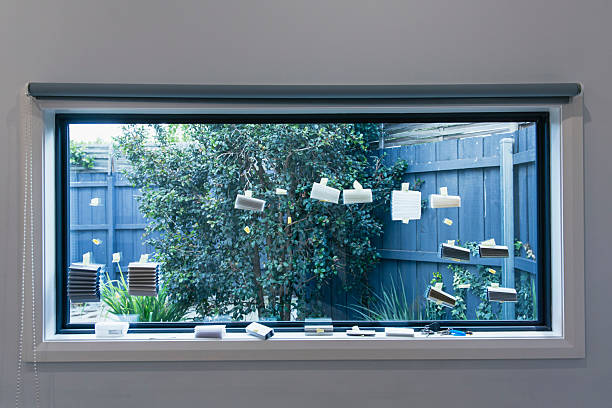 istock Kitchen window with curtain fabric samples taped to glass showcasing light and privacy options 2232370428