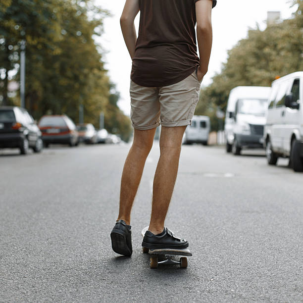 istock Man riding on a skateboard. Legs on a skateboard. 2232371357