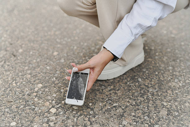 istock Anxious Female Holding Damaged Smartphone After Dropping It On Road 2232371494