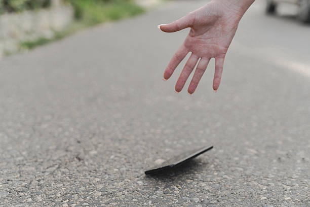 istock Anxious Female Hands Attempting To Grab Smartphone Falling Rapidly Towards Hard Surface 2232371528