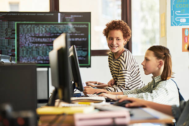 istock Teenage Caucasian Boys Collaborating on Computer Programming in Classroom 2232371590