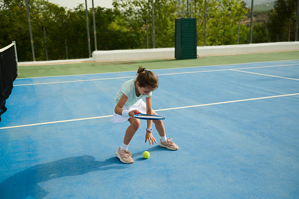 istock Young Girl Practicing Tennis Skills Outdoors on a Sunny Day 2232371809