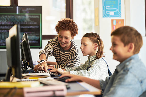 istock Group of Preteen Caucasian Children Collaborating on Coding Project in Classroom 2232372200