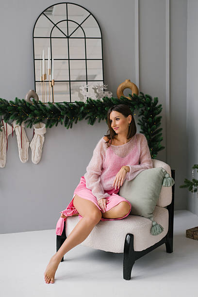 istock Woman Sitting By Christmas Decor 2232375299