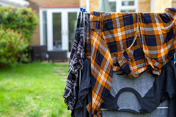 Laundry on a clothes horse in the back garden of an English house