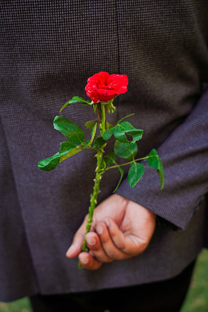 istock Romantic Red Rose Surprise: Hidden Behind a Person's Back 2232375874