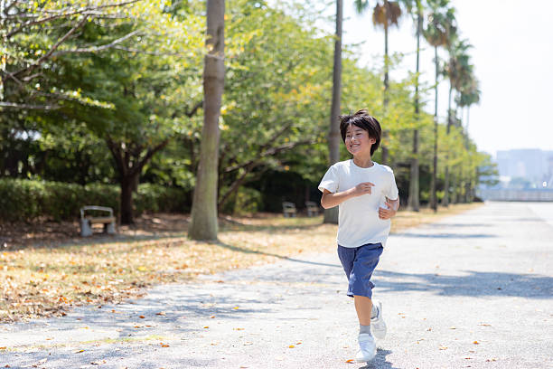 istock Little boy running in public park 2232375983