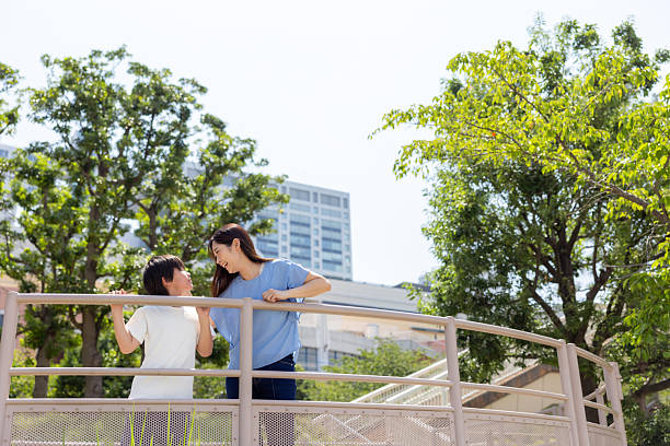 Mother and son talking in public park