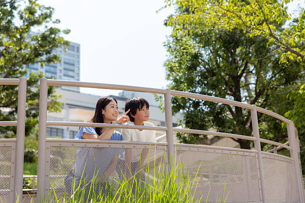Mother and son looking at view in public park