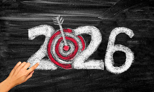 istock 2026 year with dartboard and arrow on chalkboard 2232376773