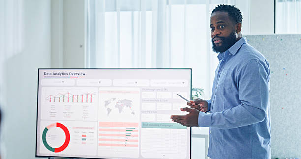 istock Closeup group of business professionals meeting discussing data analytics during a presentation, discussing strategy and growth standing at the office. Finance meeting concept. 2232377749