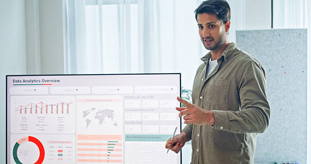 istock Closeup group of business professionals meeting discussing data analytics during a presentation, discussing strategy and growth standing at the office. Finance meeting concept. 2232377751