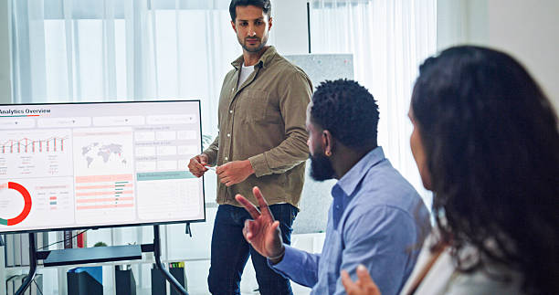 istock Group of business professionals meeting reviewing global data analytics discussing data analytics during a presentation, discussing strategy and growth standing at the office. Finance meeting concept. 2232377770