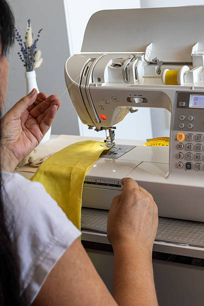 istock Crafting Yellow Fabric on a Modern Sewing Machine 2232378830