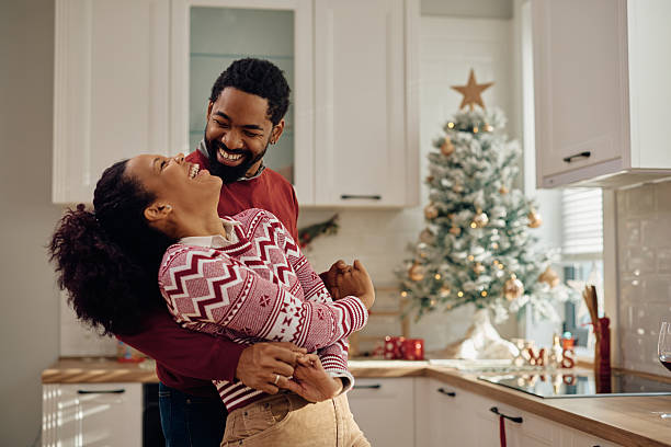 istock Joyful black couple celebrating Christmas while dancing at home. 2232378841