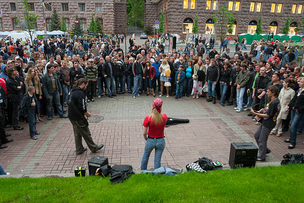 Street musicians perform for a large crowd on Khreshchatyk in Kyiv, Ukraine, urban summer editorial scene with music, community energy, and live entertainment