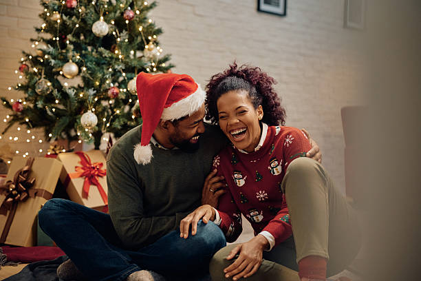 istock Joyful black couple laughing while spending Christmas together at home. 2232379361