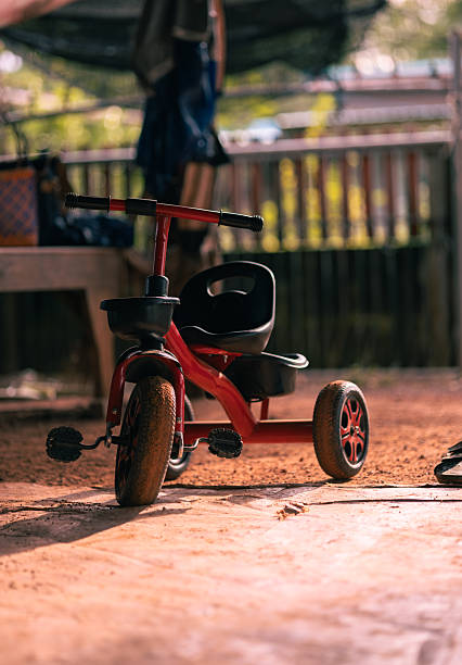 istock Child's Red Tricycle Outdoors, Playtime Memories 2232379370