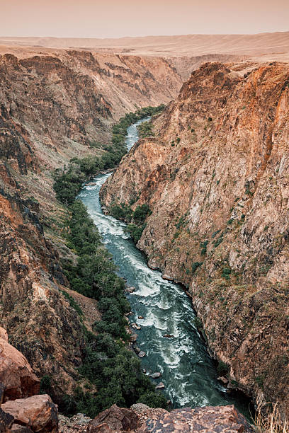 istock Scenic view of Charyn or Black Canyon with river flowing through steep cliffs at sunset, creating a breathtaking landscape in Kazakhstan 2232383225