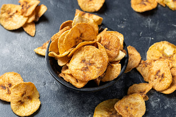 istock Crunchy Plant Based Banana Chips in a Black Bowl 2232385675