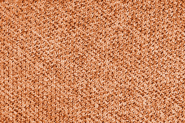 Seamless texture of orange fabric with fibers.