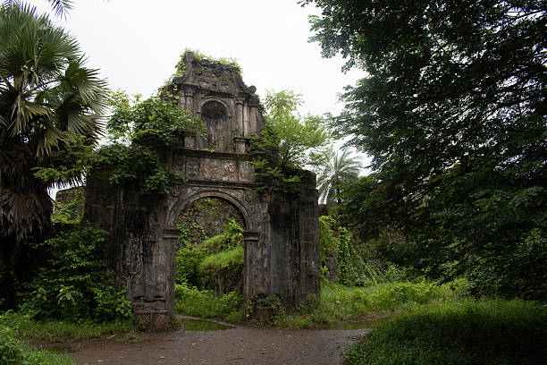istock vasai fort or bassein fort, ancient gateway with ornate arch and vegetation 2232388488