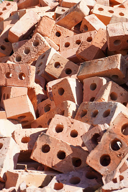 istock Pile of red clay bricks with holes 2232388839