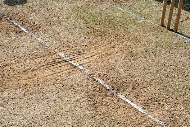 istock Worn cricket pitch showing marks at the crease 2232388922