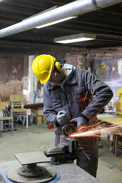 istock Metal Fabrication Process with Worker Cutting Steel Indoors 2232389044