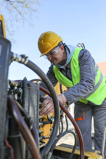 istock Senior Technician Repairing Hydraulic System on Construction Machinery Outdoors 2232391685