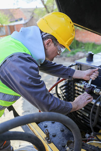 istock Senior Technician Repairing Hydraulic System on Construction Machinery Outdoors 2232391712