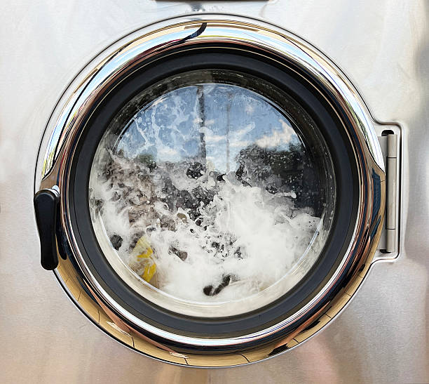 Close up view of a washing machine spinning with soap