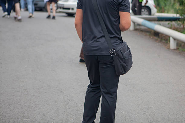 man with a bag and a backpack on the road