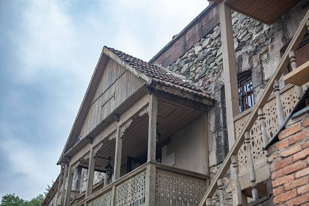 Old weathered building with peeling plaster and worn roof tiles in Novi Sad, Serbia. The faded facade and chimneys reflect the city’s layered history and architectural charm in a quiet, nostalgic atmosphere