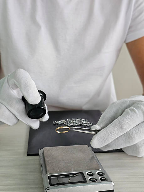 istock Jeweler examining silver pieces with tools on a scale for precise measurement 2232395872