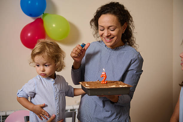 istock Mother Celebrating Child's Second Birthday With Cake and Decorations 2232398683