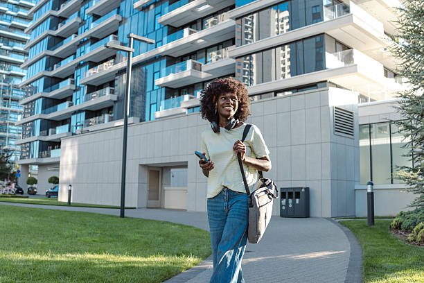 istock Smiling woman outdoors with modern building in the background 2232401189