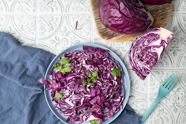 Red cabbage salad with fresh green cilantro on a plate.