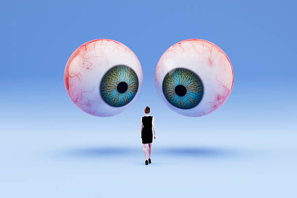 istock Internet Privacy Concept, Giant Eyeballs Watching Over a Human Figure 2232406471