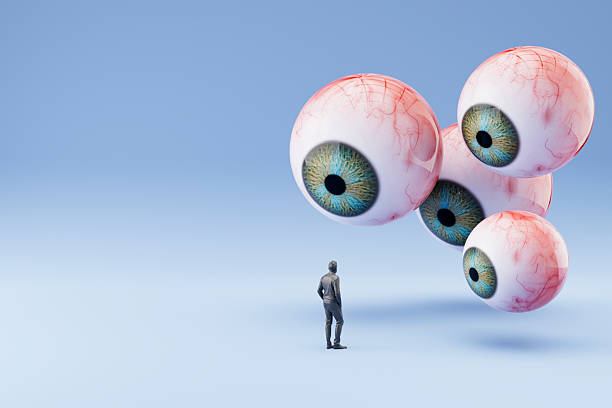 istock Internet Privacy Concept, Giant Eyeballs Watching Over a Human Figure 2232406489