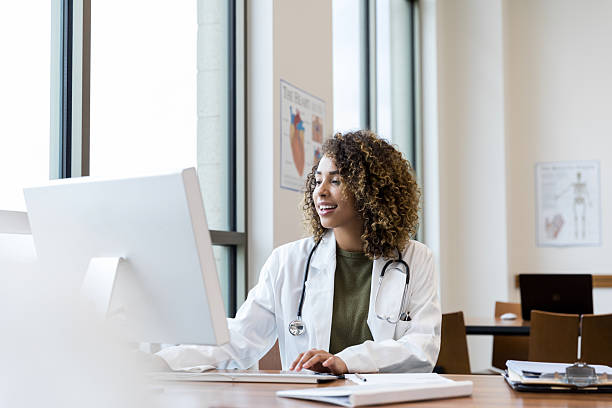 istock Smiling Female Doctor Using Computer in Medical Office 2232407151