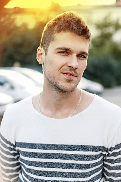 istock Handsome stylish man with a beard wearing a sweater at sunset. 2232407355