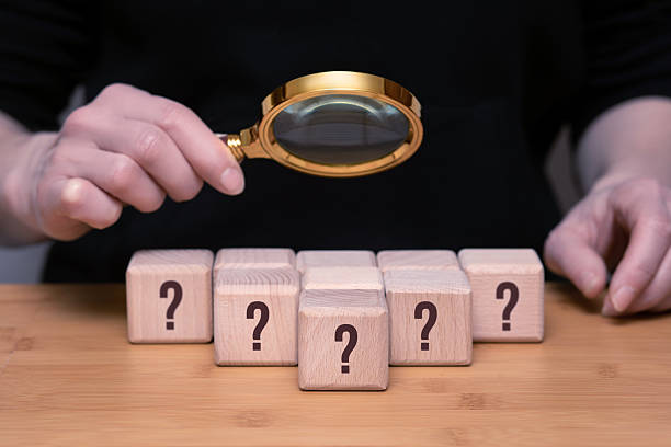 istock Exploring mysteries with a magnifying glass and wooden blocks. 2232407369