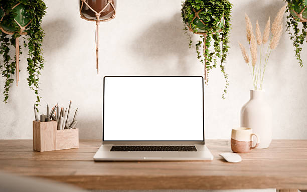 istock Laptop with blank screen mockup on a wooden desk 2232409815