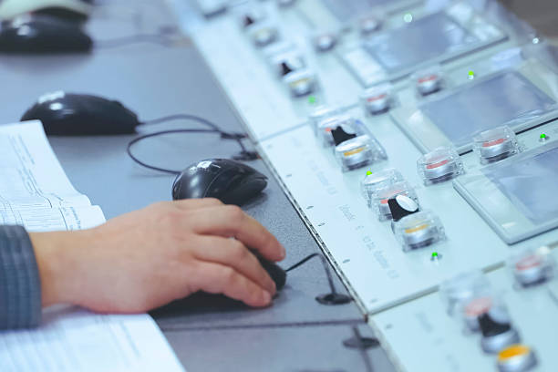 istock the operator hand holds a computer mouse at the control panel of the plant's LNG equipment. 2232412154