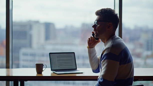 istock Occupied manager speaking phone at office with city view. Sad ceo ending call 2232414169