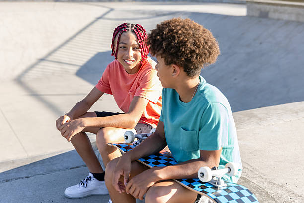 Middle school boys walking and talking at a skatepark