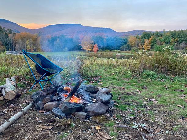 istock Camp chair by a campfire at sunset in autumn 2232416963
