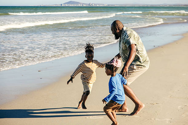 istock Running Wild: Siblings Chase Waves and Each Other 2232417378